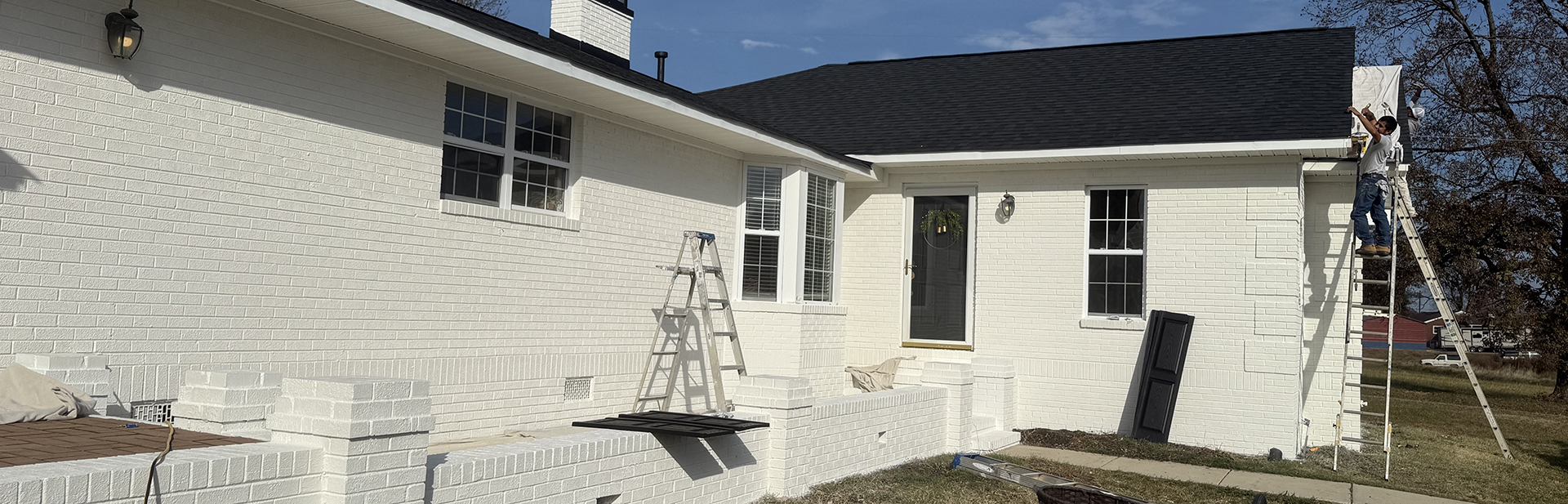 White home with new gutters.