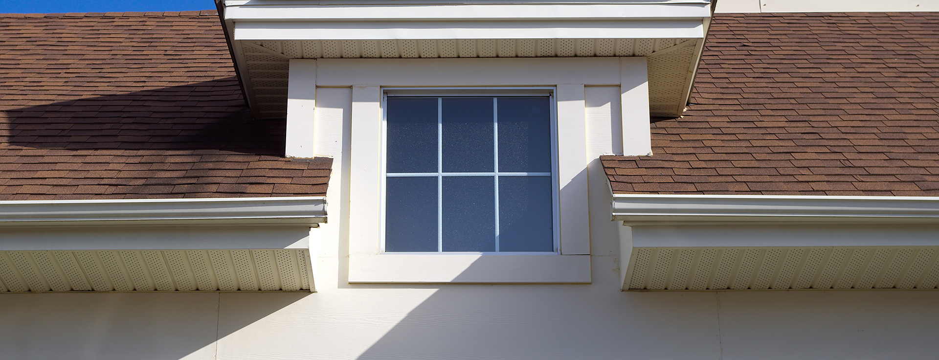 White home with new gutters.