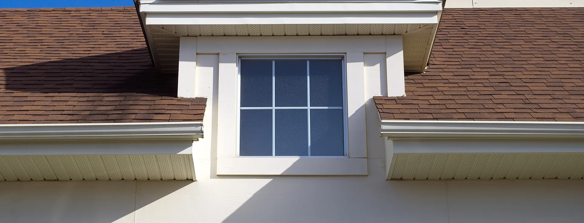 White home with new gutters.