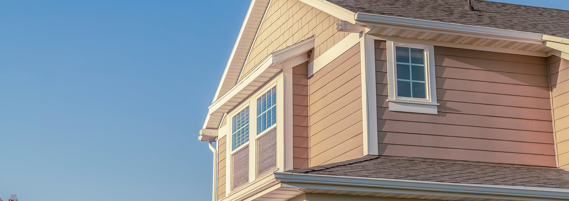 White home with new gutters.