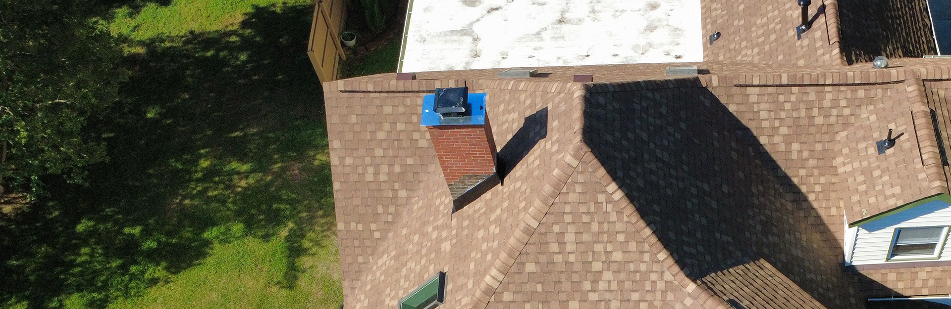 White home with new gutters.