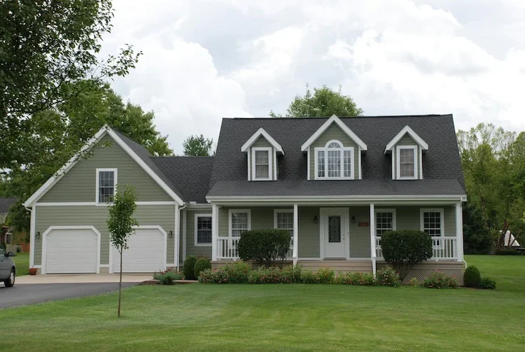 Finished residential exterior with dark roof.
