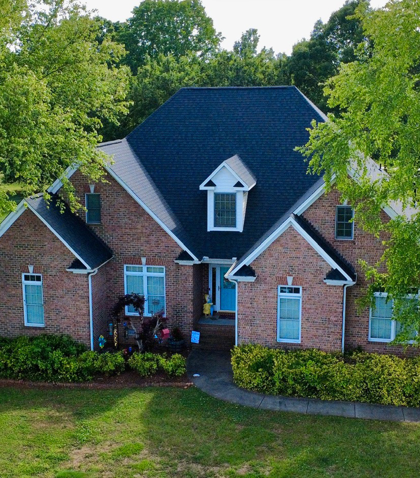 Aerial view of a new residential shingle roof.